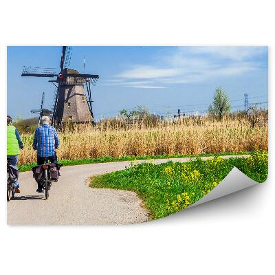 Fototapet perete Bicicliști pe drumul cu vedere la moara de vânt