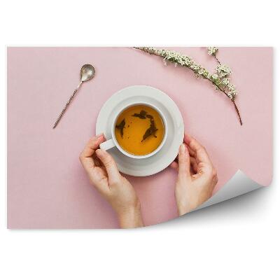 Fototapet perete Mâinile feminine cupa albă fundal roz crenguță flori