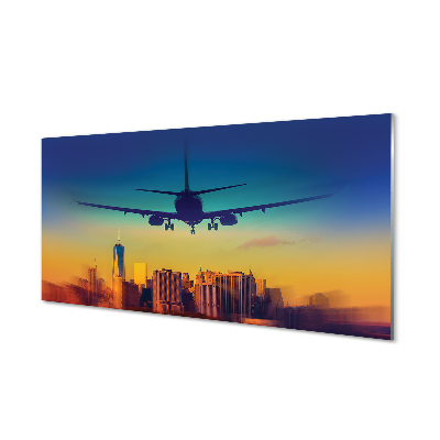 Tablou pe sticlă Avion Deasupra Orașului Cu Cer Colorat