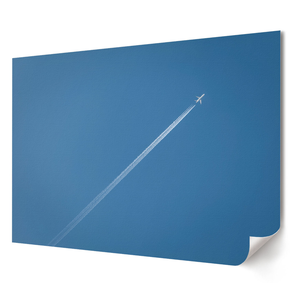 Poster de perete elegant Un avion pe un cer albastru